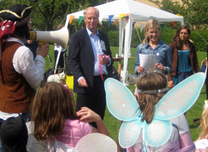 Malcolm with Jenny Ryan standing in front of little pink angels and a Batman