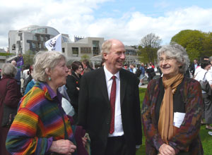 Malcolm smiling with a constituent and her friend, outside the Scottish Parliament