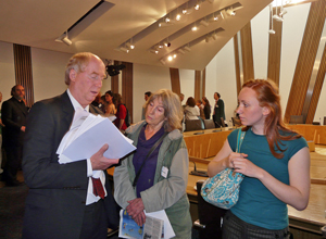 Malcolm sitting at a table with two women coffee drinkers